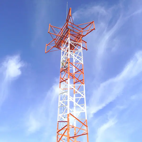 A tall tower with wires on top of it.