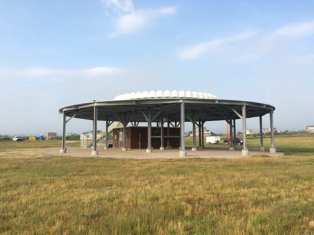 A large open field with an empty pavilion.