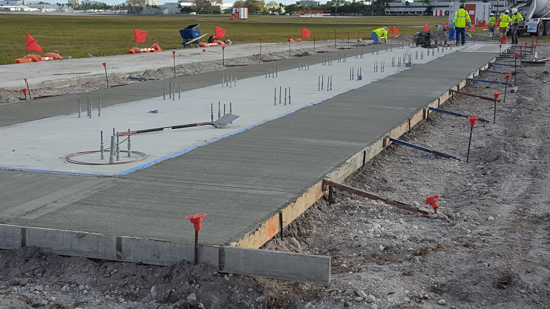 A concrete slab being poured for a building.